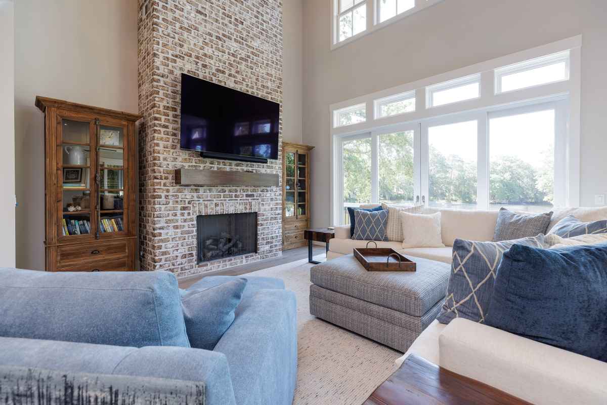 Interior photograph of an open and spacious remodeled living room and fireplace.
