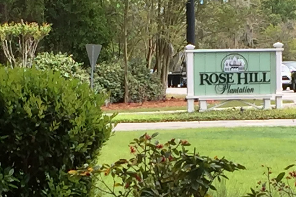 Rose Hill Sign with lush green grass and landscaping.