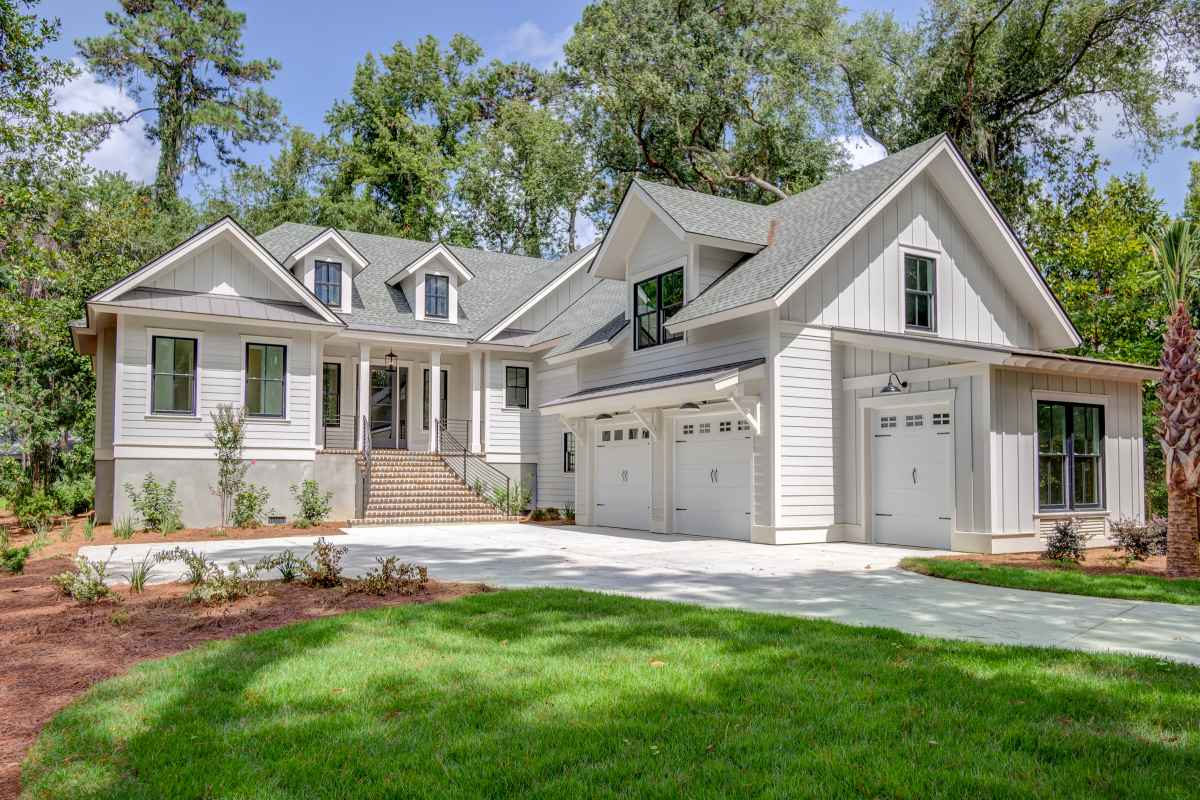 A modern, two-story house with gray siding, white trim, and a spacious garage.